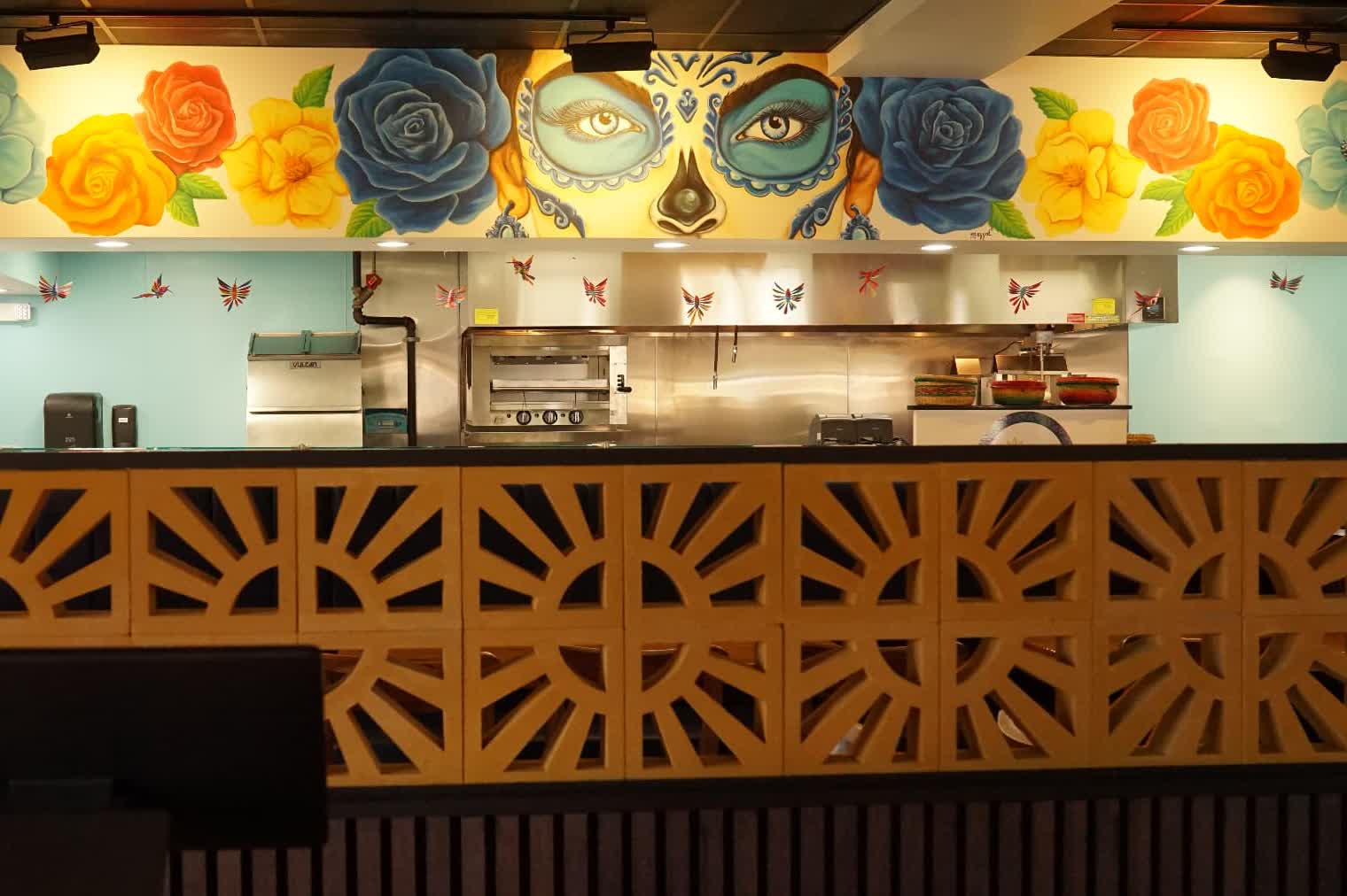 Soko Cantina dining room at night with agave plants and candlelight