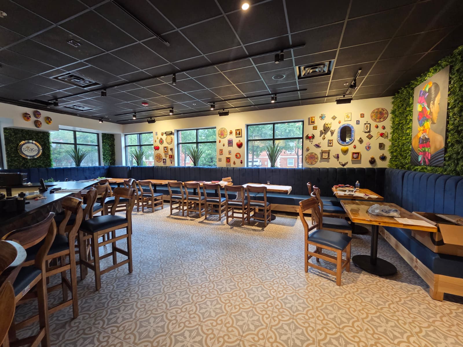 Soko Cantina dining room with navy banquette seating and folk art walls