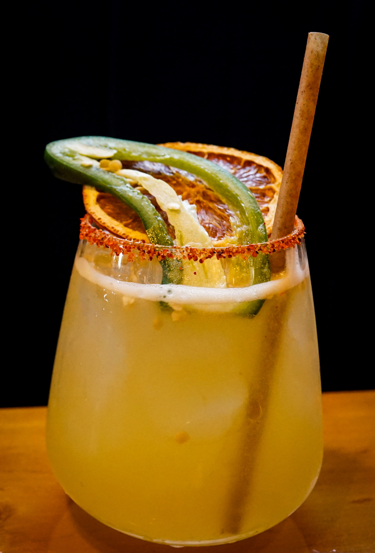 Spicy margarita with a chili-salt rim and jalapeño garnish